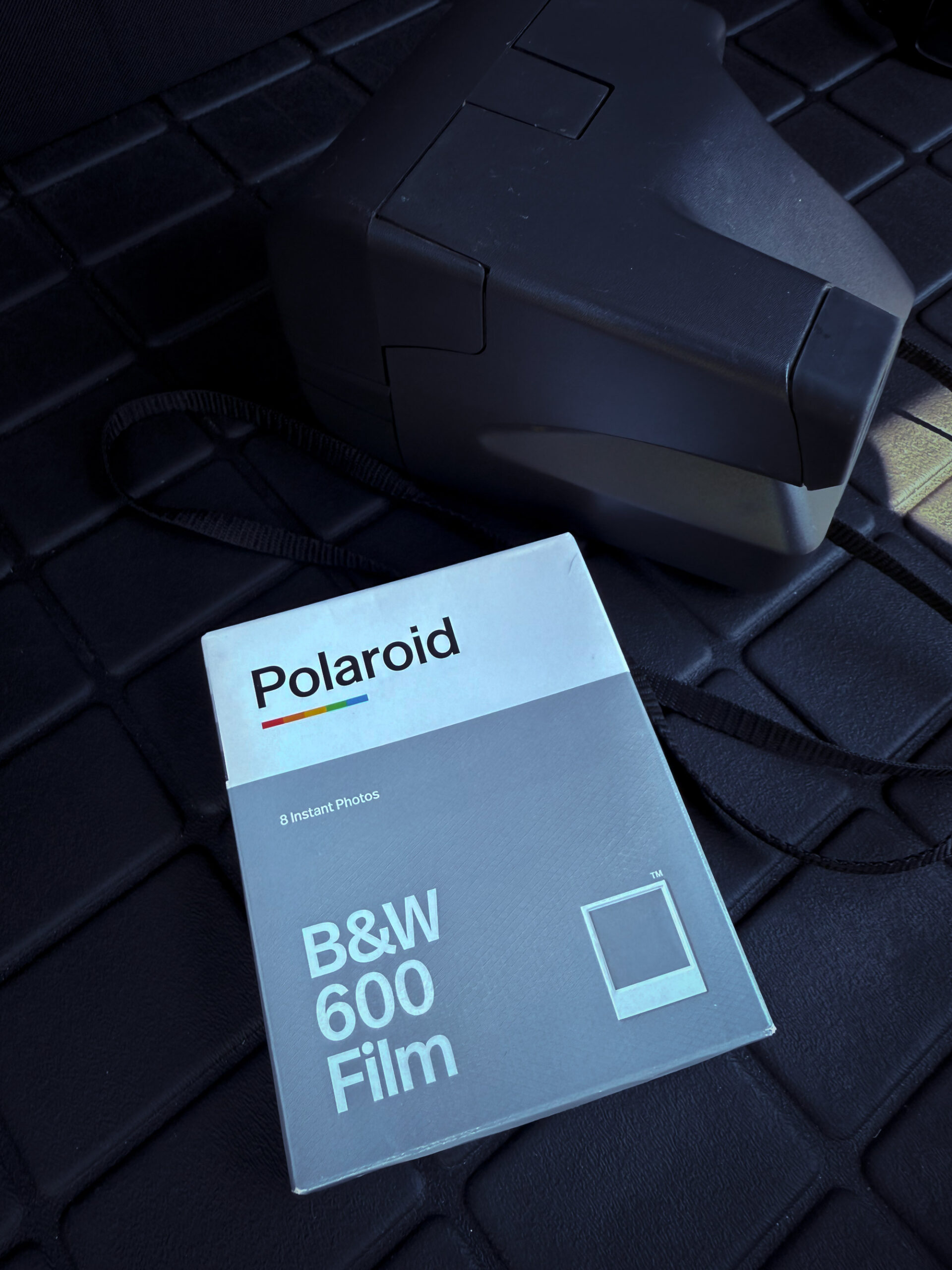 Polaroid OneStep camera with a pack of black and white 600 film.